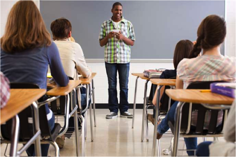 Picture of someone standing in front of a class delivering a speech